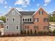 Two-story home featuring brick and siding, a dark roof, and lush front yard landscaping at 2623 Marchmont St, Raleigh, NC 27608