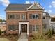 Stunning two-story brick home featuring elegant shutters and a welcoming front porch at 2623 Marchmont St, Raleigh, NC 27608