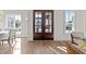 Warm and bright foyer with wood floors and a view of the home's front exterior through glass paneled double doors at 2623 Marchmont St, Raleigh, NC 27608