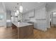 Bright kitchen featuring marble countertops, grey cabinets, stainless steel appliances, and oversized island at 2623 Marchmont St, Raleigh, NC 27608