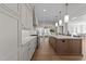 Gourmet kitchen featuring light countertops, modern cabinets, and stainless steel appliances at 2623 Marchmont St, Raleigh, NC 27608