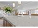 Close-up of kitchen island featuring marble countertop, gold faucet, and decorative floral arrangement at 2623 Marchmont St, Raleigh, NC 27608