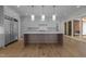 Expansive kitchen features grey cabinets, stainless steel appliances, marble countertops, and oversized island at 2623 Marchmont St, Raleigh, NC 27608