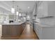 Spacious kitchen features an oversized island with marble countertops, modern appliances, and beautiful pendant lighting at 2623 Marchmont St, Raleigh, NC 27608