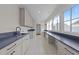 Bright laundry room with long workspace, storage, modern cabinets, and lots of natural light at 2623 Marchmont St, Raleigh, NC 27608