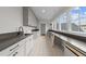 Laundry room with white cabinets, gray countertops, sink, and window views at 2623 Marchmont St, Raleigh, NC 27608