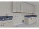 Laundry room with sink, modern cabinets, unique backsplash and countertop space at 2623 Marchmont St, Raleigh, NC 27608