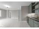 Living area with wet bar featuring blue-gray cabinets, beverage center and neutral walls and trim at 2623 Marchmont St, Raleigh, NC 27608