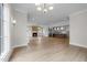 Open-concept living space with hardwood floors connecting to a modern kitchen at 2623 Marchmont St, Raleigh, NC 27608