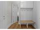 Bright mudroom with white cabinets, wood bench, and gold hooks at 2623 Marchmont St, Raleigh, NC 27608