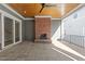 Outdoor patio featuring a brick fireplace, stone flooring, and sliding glass doors at 2623 Marchmont St, Raleigh, NC 27608