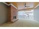 Back patio with brick fireplace, stone flooring, wood ceiling, and overhead fan at 2623 Marchmont St, Raleigh, NC 27608