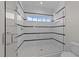 Modern shower with glass door, horizontal black stripes and mosaic tile flooring at 2623 Marchmont St, Raleigh, NC 27608