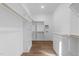 Bright walk-in closet features custom shelving, wood floors, and convenient access to the laundry area at 2623 Marchmont St, Raleigh, NC 27608