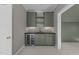 Charming wet bar featuring a wine cooler, cabinets, and a stylish backsplash, perfect for entertaining at 2623 Marchmont St, Raleigh, NC 27608