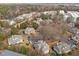 An aerial view of a community of gray homes surrounded by trees and parking lots at 2821 Edridge Ct # 102, Raleigh, NC 27612