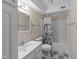 A cozy bathroom featuring a bathtub, shower, and floral wallpaper at 2821 Edridge Ct # 102, Raleigh, NC 27612