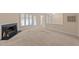 A spacious living room with carpet, fireplace, and natural light at 2821 Edridge Ct # 102, Raleigh, NC 27612