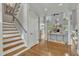 Grand foyer featuring hardwood floors, staircase, and an inviting view into the living area at 296 Shoreline Dr, Princeton, NC 27569