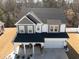 Aerial view of a charming two-story home with a well-manicured lawn and inviting front porch at 318 Highland Forest Dr, Fuquay Varina, NC 27526