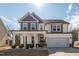 Beautiful two-story home with a covered front porch, white columns, and a two-car garage at 318 Highland Forest Dr, Fuquay Varina, NC 27526