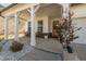 Inviting front porch with white columns, seating, and a wooden door, enhancing curb appeal at 318 Highland Forest Dr, Fuquay Varina, NC 27526
