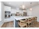 Modern kitchen featuring white cabinetry, stainless steel appliances, and a large central island at 318 Highland Forest Dr, Fuquay Varina, NC 27526