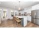 Bright kitchen features a large island, stainless steel appliances, and modern finishes at 318 Highland Forest Dr, Fuquay Varina, NC 27526