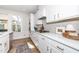 Close up of kitchen showcasing white cabinets, gold hardware, and herringbone backsplash at 318 Highland Forest Dr, Fuquay Varina, NC 27526