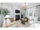 Bright living room features fireplace, large windows, and neutral decor at 318 Highland Forest Dr, Fuquay Varina, NC 27526