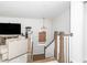 Open concept living room features wooden stairs and cozy furniture at 318 Highland Forest Dr, Fuquay Varina, NC 27526
