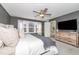 Spacious main bedroom offers large windows and a ceiling fan at 318 Highland Forest Dr, Fuquay Varina, NC 27526