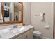 Updated bathroom featuring a stylish vanity, mirror, and convenient washer/dryer at 3212 Oxford Dr, Durham, NC 27707
