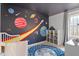 Charming bedroom with custom space themed wall art and neutral carpeting at 3212 Oxford Dr, Durham, NC 27707