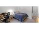 Well-lit bedroom showcasing a cozy bed with patterned pillows and a functional side table at 3212 Oxford Dr, Durham, NC 27707