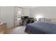 Bright bedroom features neutral walls, a blue patterned coverlet, and a functional work space at 3212 Oxford Dr, Durham, NC 27707