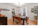 Dining room with wood floors, chandelier, and a view into the adjacent kitchen at 3212 Oxford Dr, Durham, NC 27707