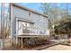 Exterior view of backyard and deck with outdoor seating, complemented by lush landscaping at 3212 Oxford Dr, Durham, NC 27707