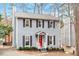 Charming gray two-story home featuring a bright red front door and neatly trimmed landscaping at 3212 Oxford Dr, Durham, NC 27707