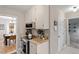 Bright kitchen with stainless steel appliances, white cabinetry, and a view into the dining room at 3212 Oxford Dr, Durham, NC 27707