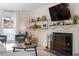 Comfortable living room featuring a fireplace, hardwood floors, and a bright window view at 3212 Oxford Dr, Durham, NC 27707