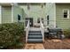 A rear view of the home and the back deck with stairs leading down to the yard at 3304 Glen Currin Dr, Raleigh, NC 27612