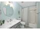 A refreshing bathroom with patterned tile, a round mirror, and a shower-tub combination at 3304 Glen Currin Dr, Raleigh, NC 27612