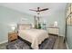 Relaxing bedroom with light green walls, ceiling fan, a neutral color palette, and a connected bathroom at 3304 Glen Currin Dr, Raleigh, NC 27612