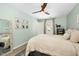 Bedroom features light green walls, ceiling fan, a large mirror, and a neutral color palette at 3304 Glen Currin Dr, Raleigh, NC 27612