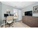 A home office setup by a window with built in media storage at 3304 Glen Currin Dr, Raleigh, NC 27612