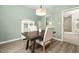 Cozy dining space featuring modern decor, a wooden table, and a view of the backyard at 3304 Glen Currin Dr, Raleigh, NC 27612