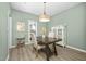 Elegant dining room with a wooden table, stylish lighting, and a vintage bar cart at 3304 Glen Currin Dr, Raleigh, NC 27612