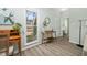 Bright entryway features wood flooring, a vintage desk, and a large window with a view of the neighborhood at 3304 Glen Currin Dr, Raleigh, NC 27612