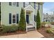 Inviting front porch with a dark blue front door and elegant white trim at 3304 Glen Currin Dr, Raleigh, NC 27612